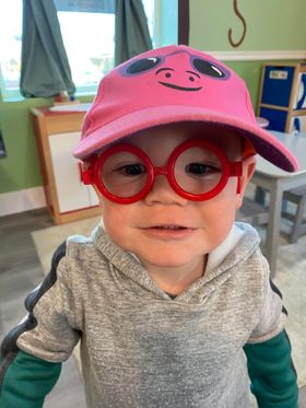 Baby Wearing Glasses and Pink Hat